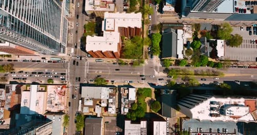 Streets and crossroads filled with cars moving by. Traffic in metropolis at daytime. Top view.
