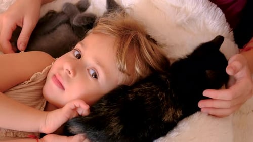 Happy Girl Cuddling Adorable Kittens