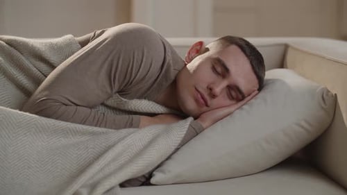 Young Man Sleeping Peacefully on a Couch