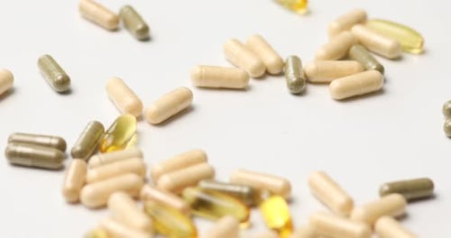 Assorted Pills and Capsules on White Background