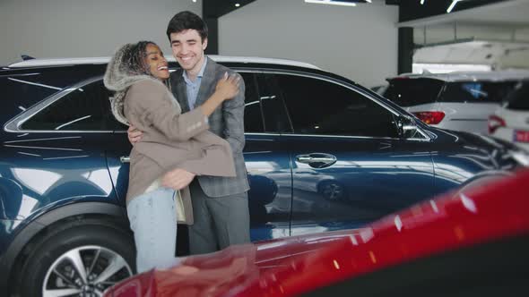 Man Surprises Woman with a Car Reveal in Modern Showroom Filled with ...