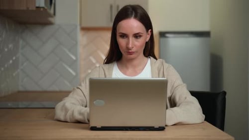 Woman Using Laptop Computer at Home