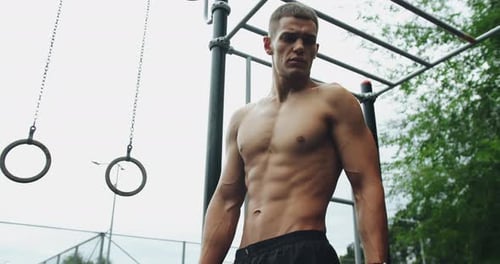 Muscular Man at Outdoor Urban Calisthenics Gym