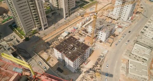 Aerial establish construction site with cranes in residential district