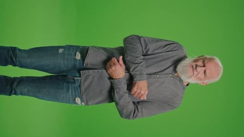 Senior Man Rubbing Arm in Pain on Green Screen