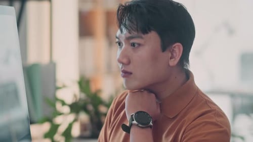 Young Adult Working at Computer with Keyboard