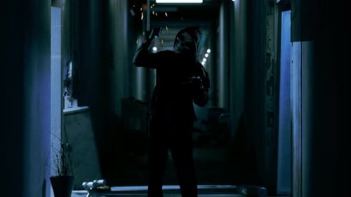 Scary Man Wearing Ghost Mask Stabbing With A Knife For Making Threatening In The Abandoned Hotel