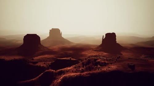 Aerial View of a Vast Desert Landscape with Scattered Rocks in the Distance