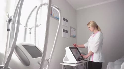 Woman Operates Medical Machine with Touchscreen in Clinic