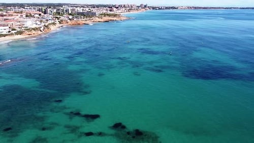 Aerial drone view of cityscape and coastline of Mil Palmeras beach and Pilar de la Horadada in Spain