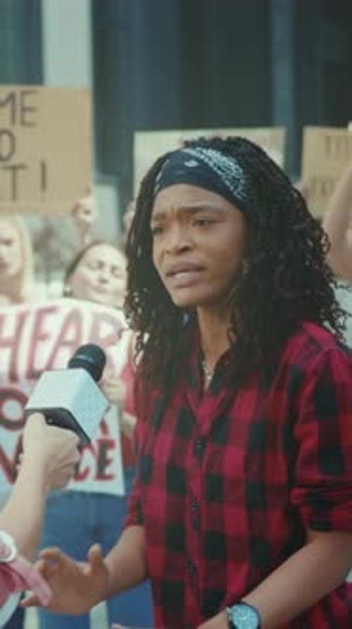 Female Speaker Rallies Crowd Assertively Empowered Woman Addresses Supporters at Public