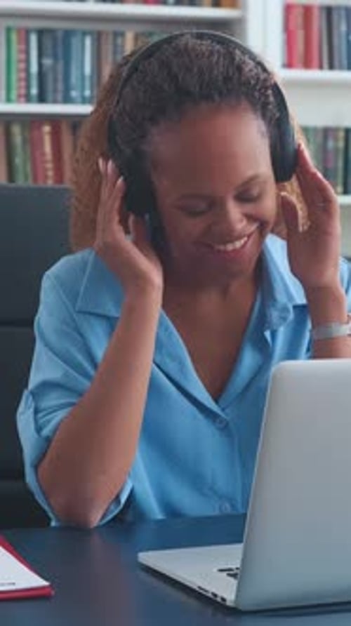 Woman Wearing Headphones Talking in Home Office