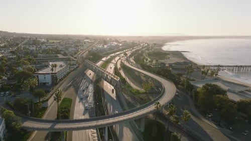 Aerial Footage of Multilevel Road Intersection and Railway Bridge in City Morning Shot at Sunrise