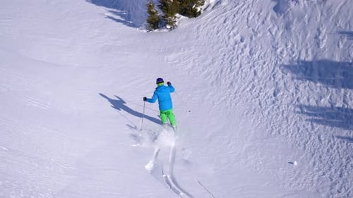 Aerial View of Skier Carving Down Snowy Slope