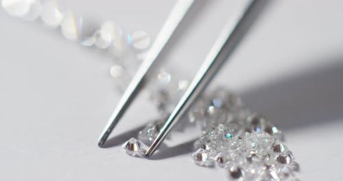 Tweezers Pick Up a Loose Diamond