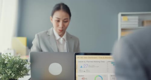 Group of people discussing business shaking hands together and smiling while sitting in office.
