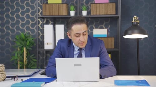 Tired Man Working At His Computer In Office