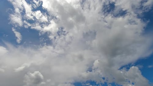 Clouds Drifting Slowly Across a Blue Sky