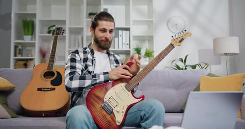 Man Explains Guitar Techniques in Online Lesson