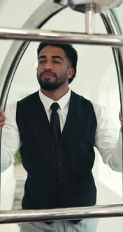 Porter, walking and luggage with man in hotel for hospitality, valet service and baggage handler