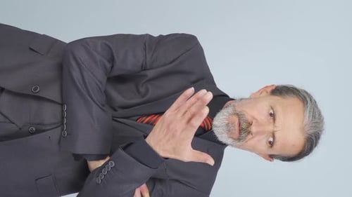 Man in Suit Gesturing in Portrait Orientation