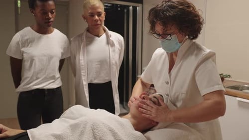 Esthetician Students Learning Facial Massage Techniques in Spa