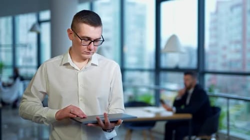 Young confident smart office worker. Handsome businessman working in the modern office.