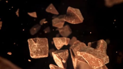 Chunks of chocolate falling in slow motion studio