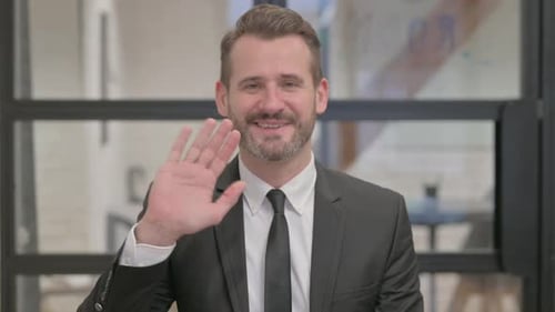 Portrait of Middle Aged Businessman Waving Hand to Say Hello