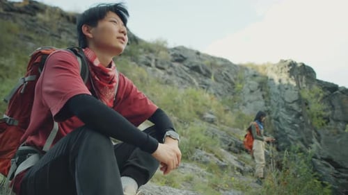 People Hiking up a Rocky Mountain