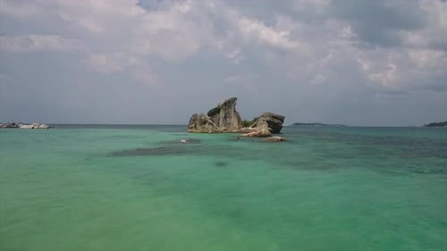 rock in the middle of the sea when the sea water is shallow