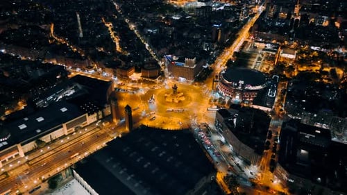 Aerial drone view of Plaza of Spain in Barcelona at evening, Spain. Roundabout with moving cars, bui