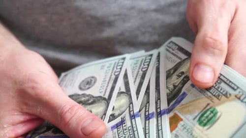 Counting Stack of One Hundred Dollar Bills