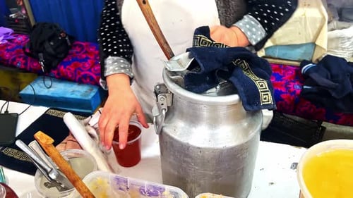 pure natural honey transferring into a plastic bottle in the market, world oldest Silk Road Market i