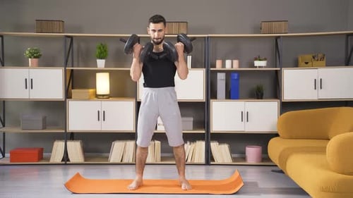 Body building. Fitness man lifts dumbbells.
