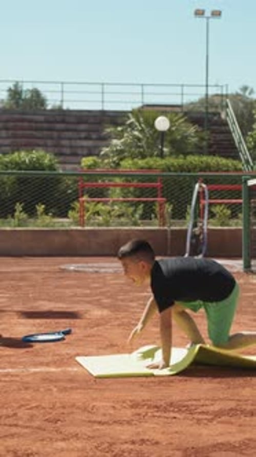 Children Learn Tennis With Female Teacher In Outdoor Court At School