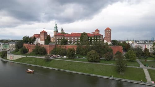 Cinematic aerial shot of a red castle in krakow poland on an overcast day