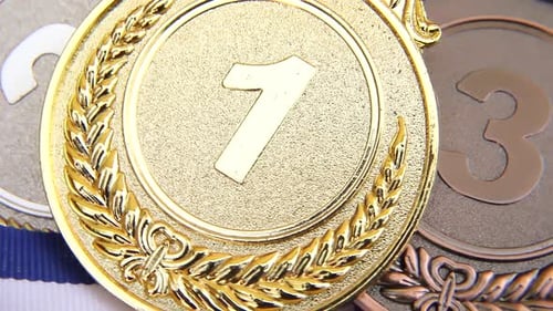 Top View of Winner or Champion Gold Silver Bronze Trophy Medal Rotating on White Background