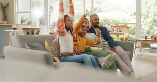 Family Laughing Together Watching TV in Living Room