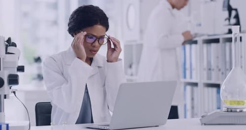 Stressed Scientist Working on Laptop in Lab