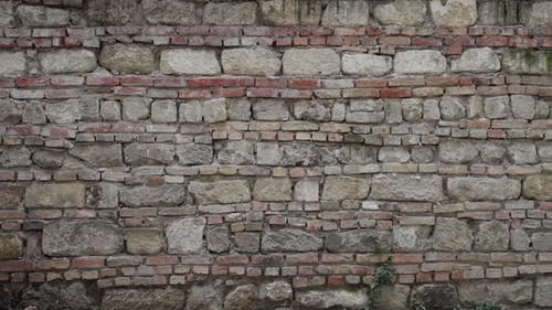 Detailed view of a weathered stone wall with bricks