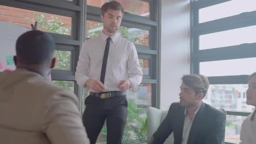 Lower view of business team with multiethnic discuss in meeting area using board look happy