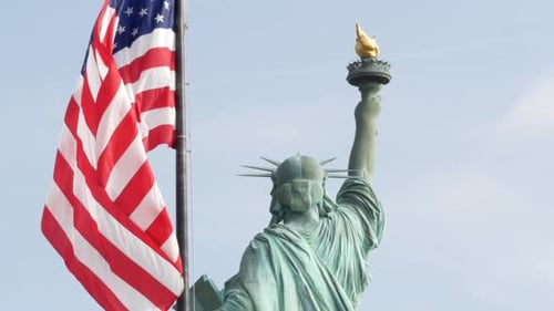 Statue of Liberty with American Flag Waving Proudly