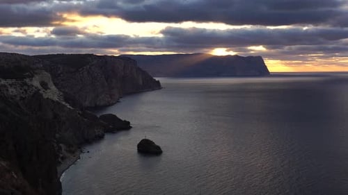 Sea Landscape with Rocky Coastline on Sunset Time with Cloudy Sky