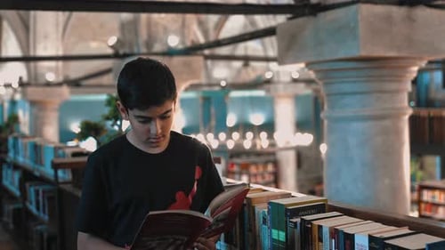 Boy Reads A Book In A Historical Library
