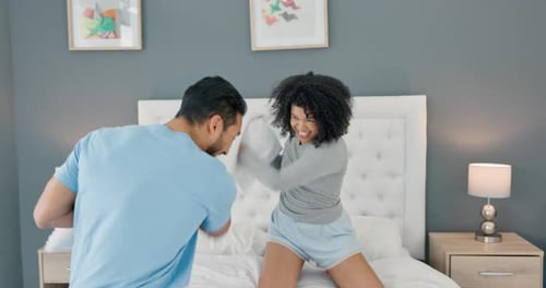 Couple Laughing and Having Fun Pillow Fight