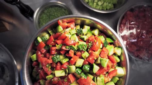 Overhead Shot of Tomato Cucumber Salad Being Prepared