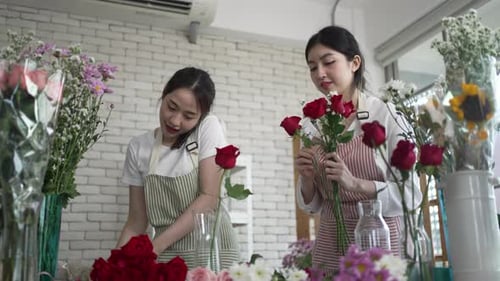 Young entrepreneurs are working at florist shop.