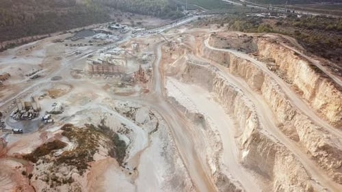 Stone sorting station in a large Quarry, with rocks transported on conveyor belts, Aerial view.