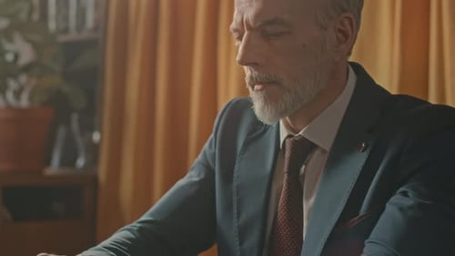 Middle Aged Entrepreneur Working on Laptop in Restaurant